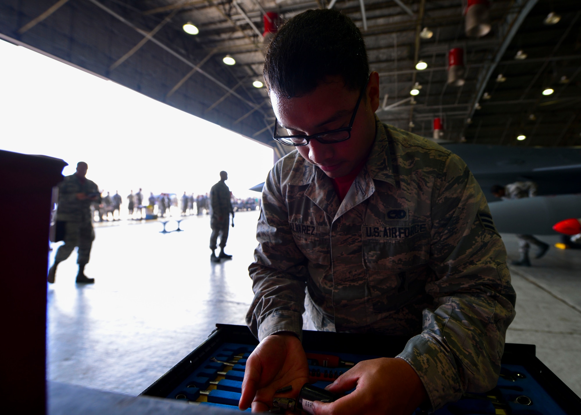 Senior Airman Jeremy Alvarez, 25th Aircraft Maintenance Unit weapons load crew member, looks for a specific item in a toolset at Osan Air Base, Republic of Korea, July 7, 2016. Alvarez was part of the 36th AMU weapons load crew competing for the 51st Maintenance Group Weapons Load Crew of the Quarter award. The teams were judged on dress and appearance in addition to their job skill and ability. (U.S. Air Force photo by Senior Airman Victor J. Caputo/Released)