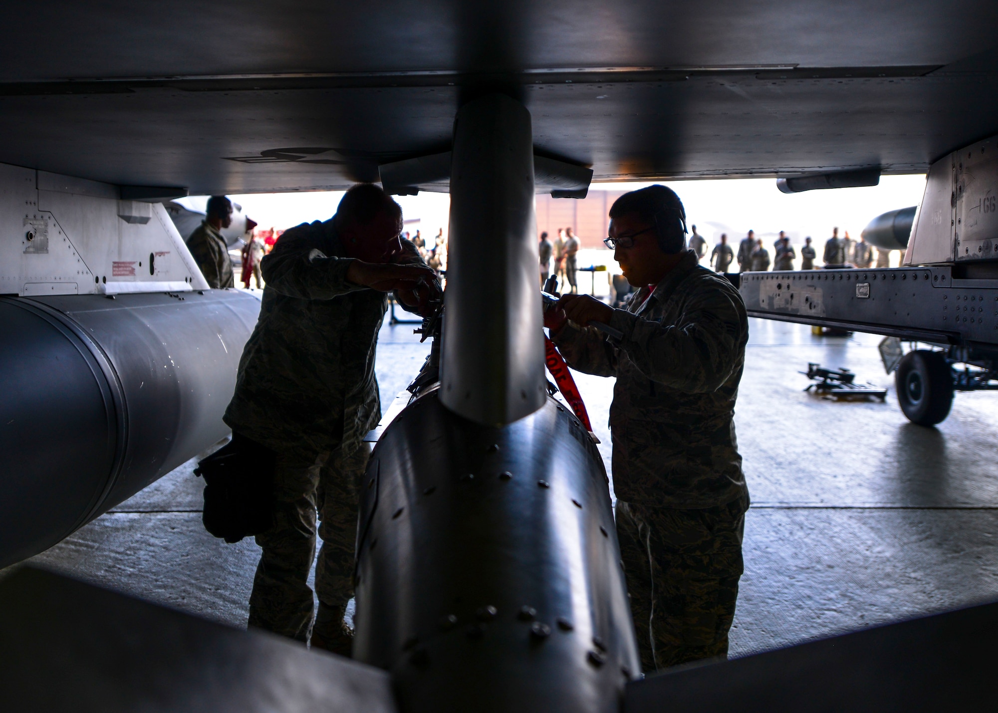 A weapons load crew from the 36th Aircraft Maintenance Unit performs an inspection check to ensure proper connections between a missile and an F-16 Fighting Falcon during the 51st Maintenance Group Weapons Load Crew of the Quarter competition at Osan Air Base, Republic of Korea, July 7, 2016. Weapons load teams from the 25th and 36th AMUs competed by loading training bombs and missiles onto their respective aircraft during the event. (U.S. Air Force photo by Senior Airman Victor J. Caputo/Released)