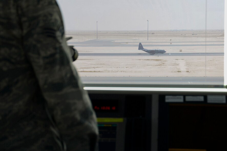 U.S. Air Force Senior Airman Ryan Colomo, 379th Expeditionary Operations Support Squadron Air Traffic Control journeyman, surveys an aircraft as it lands on the runway at Al Udeid Air Base, Qatar, June 13, 2016. Incoming aircraft must first contact the tower before making their final approach, and ATC members such as Colomo, a native of Mechanicsville, Md., approve and direct the aircraft safely across the runway. (U.S. Air Force photo by Senior Airman Kimberly Nagle) 