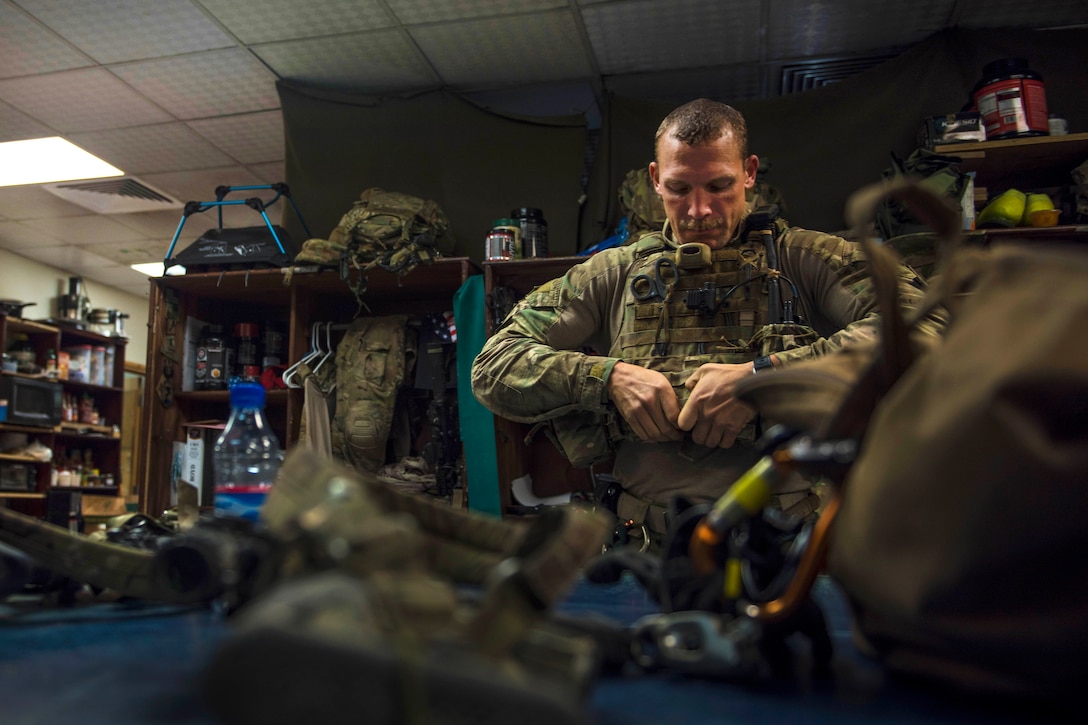 Air Force Staff Sgt. Roderick Campbell puts on his gear before participating in a personnel recovery exercise at Bagram Airfield, Afghanistan, July 9, 2016. Campbell is a pararescueman assigned to the 83rd Expeditionary Rescue Squadron. Air Force photo by Senior Airman Justyn M. Freeman