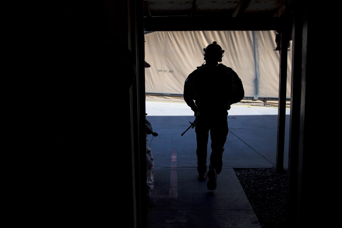 Air Force Staff Sgt. Roderick Campbell makes his way to an HH-60G Pave Hawk helicopter before participating in a personnel recovery exercise at Bagram Airfield, Afghanistan, July 9, 2016. Campbell is a pararescueman assigned to the 83rd Expeditionary Rescue Squadron. Air Force photo by Senior Airman Justyn M. Freeman