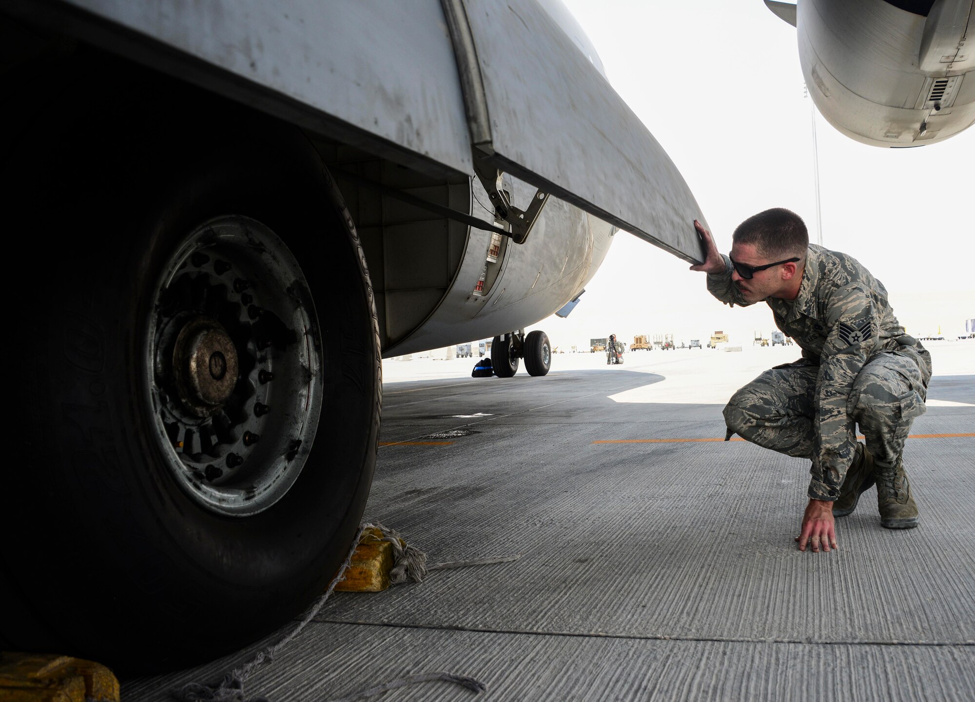 Staff Sgt. Josh Budinich, 8th Expeditionary Air Mobility Squadron, Aircraft Maintenance flight aero repair craftsman, inspects the tires of a C-17 Globemaster III during a preflight inspection June 30, 2016, at Al Udeid Air Base, Qatar. Budinich takes approximately three hours to inspect the whole aircraft, inside and out, from its tires and brakes to the oil in its engines. Due to the warm weather here, Airmen keep the aircraft at a constant temperature while operating on any of the systems on the aircraft to prevent additional issues from occurring. (U.S. Air Force photo/Senior Airman Janelle Patiño/Released)
