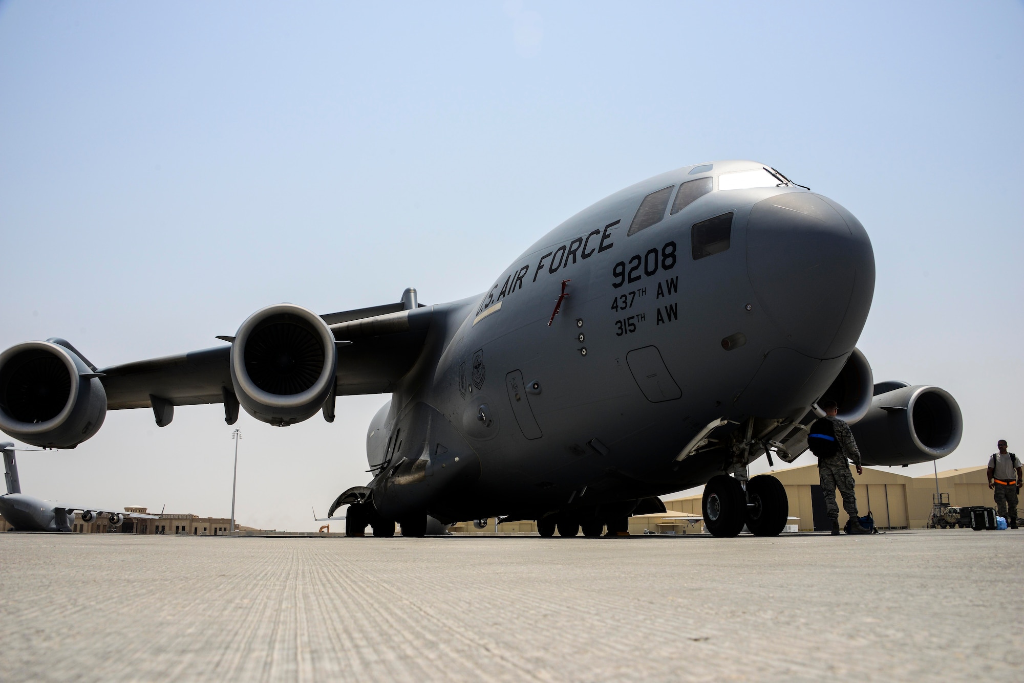 A C-17 Globemaster III sits on the flight line while Airmen from the 8th Expeditionary Air Mobility Squadron, Aircraft Maintenance Flight finish their preflight inspection June 30, 2016, at Al Udeid Air Base, Qatar. The 8 EAMS provides airlift capability to units across the U.S. Air Forces Central Command area of responsibility in support of Operation Inherent Resolve, Freedom Sentinel and Combined Joint Task Force - Horn of Africa. (U.S. Air Force photo/Senior Airman Janelle Patiño/Released)