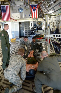 Master Sgt. Sean R. Smith, NCO in charge of aircrew training for the 445th Aeromedical Evacuation Squadron, observes and coaches Airmen from the 445th AES, the 932nd AES from Scott Air Force Base, Illinois, and the 439th AES from Westover Air Reserve Base, Massachusetts, as they participate in the Aeromedical Evacuation Initial Qualification course June 6, 2016. The Airmen practiced litter patient loading and unloading on a C-17 Globemaster III cargo aircraft. (U.S. Air Force Photo by Senior Airmen Joel A. McCullough)