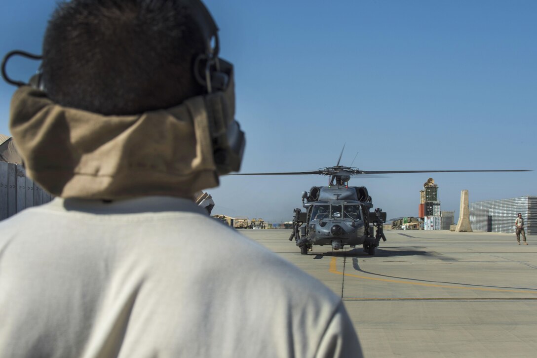 Airman 1st Class Raul Perales prepares to marshal an HH-60G Pave Hawk helicopter before participating in a personnel recovery exercise at Bagram Airfield, Afghanistan, July 9, 2016. Perales is a crew chief assigned to the 455th Expeditionary Aircraft Maintenance Squadron. Air Force photo by Senior Airman Justyn M. Freeman 