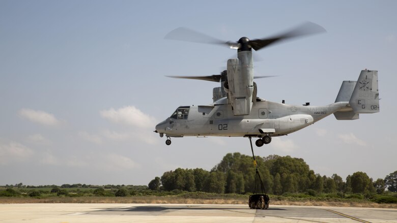 An MV-22B Osprey with Marine Medium Tiltrotor Squadron 263, Special Purpose Marine Air-Ground Task Force-Crisis Response-Africa, drops a 1,098 pound pallet of Meals, Ready to Eat during a helicopter support team exercise at Naval Station Rota, Spain, July 6, 2016. External lifts allow pilots to deliver large cargo and supplies to Marines located in rough or unknown terrain without having to land the helicopter.