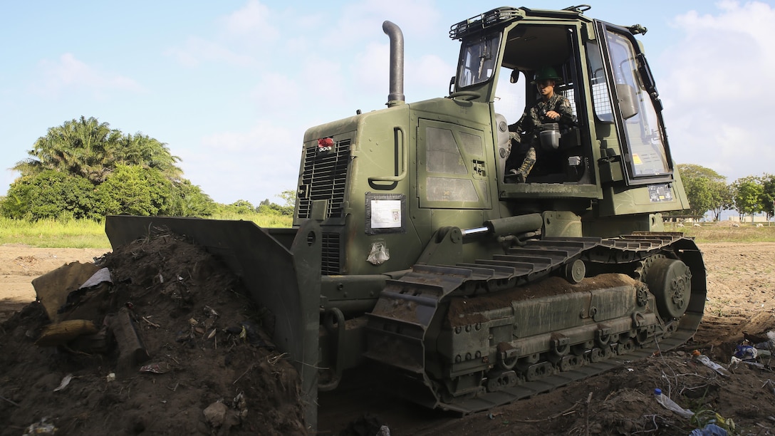 A Honduran engineer operates a D6K Bulldozer during a partner nation construction project between Honduran service members and U.S. Marines with Special Purpose Marine Air-Ground Task Force - Southern Command at Puerto Castilla, Honduras, June 24, 2016. The Marines worked side by side with their Honduran counterparts on different construction and restoration projects, and shared knowledge and experience on techniques including maintenance and operation of heavy equipment.