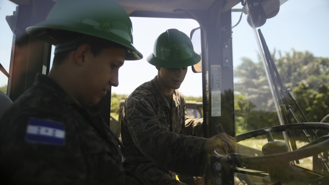 Cpl. Ivan A.  Barbosa, a heavy equipment operator with Special Purpose Marine Air-Ground Task Force - Southern Command, conducts a period of instruction on basic operation and capabilities of a 624KR TRAM during a construction project between Honduran service members and U.S. Marines at Puerto Castilla, Honduras, June 24, 2016. The Marines worked side by side Honduran engineers on different construction and restoration projects, and shared knowledge and experience on techniques including maintenance and operation of heavy equipment.