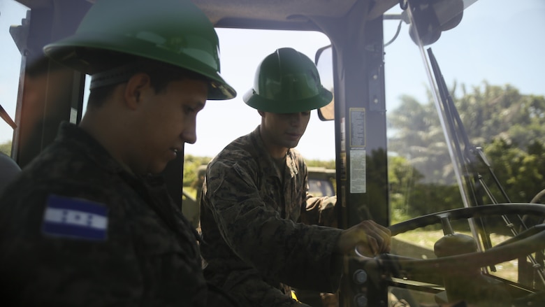 Cpl. Ivan A.  Barbosa, a heavy equipment operator with Special Purpose Marine Air-Ground Task Force - Southern Command, conducts a period of instruction on basic operation and capabilities of a 624KR TRAM during a construction project between Honduran service members and U.S. Marines at Puerto Castilla, Honduras, June 24, 2016. The Marines worked side by side Honduran engineers on different construction and restoration projects, and shared knowledge and experience on techniques including maintenance and operation of heavy equipment.