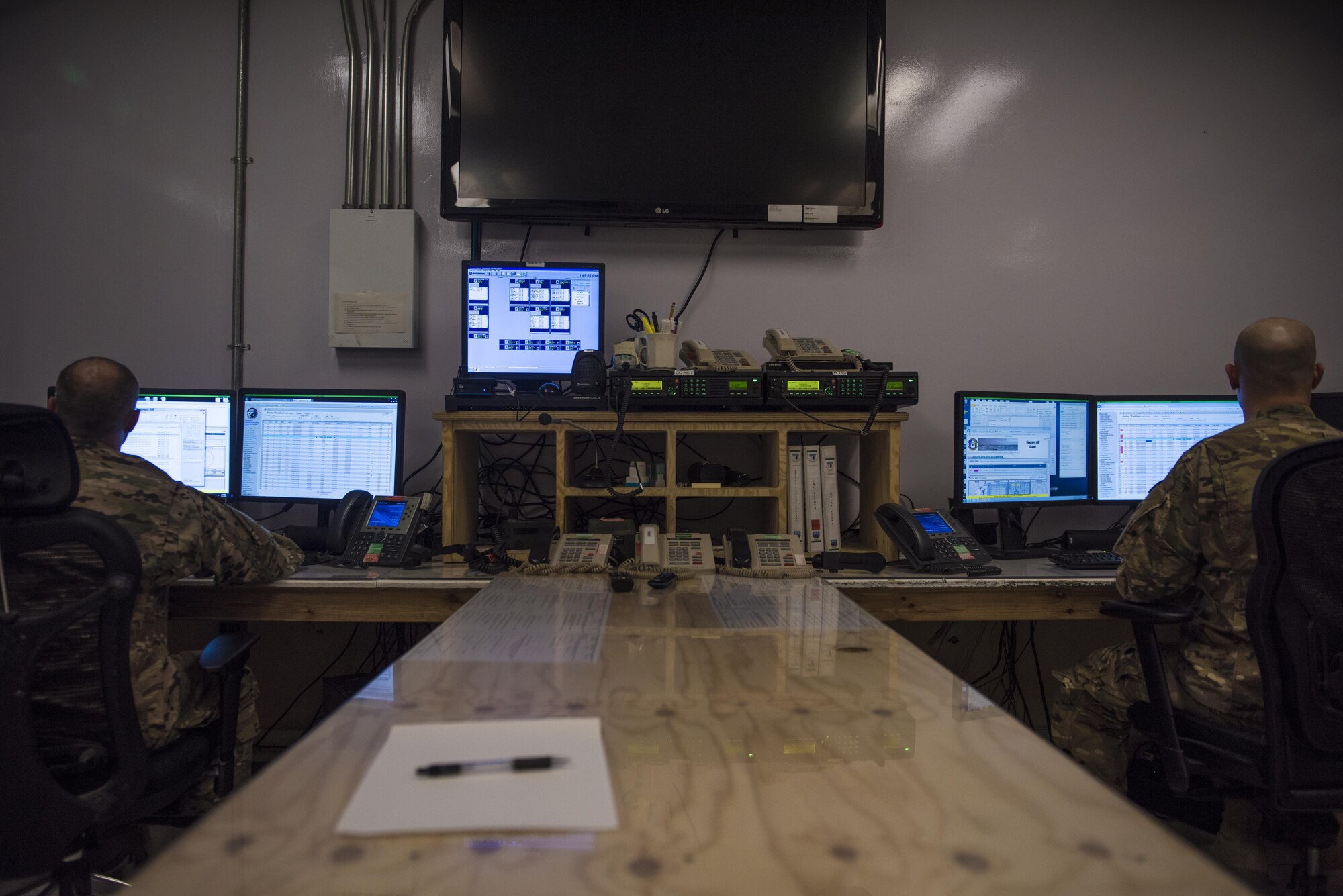 Tech. Sgt. Alexander Mears (left), 455th Air Expeditionary Wing senior command post controller, and Staff Sgt. Scott Felando (right), 455th AEW command post controller, check aircraft statuses, July 11, 2016, Bagram Airfield, Afghanistan. Members of the 455th AEW command post serve as an operations focal point for the Bagram flightline and relay information to wing leadership. (U.S. Air Force photo by Senior Airman Justyn M. Freeman)