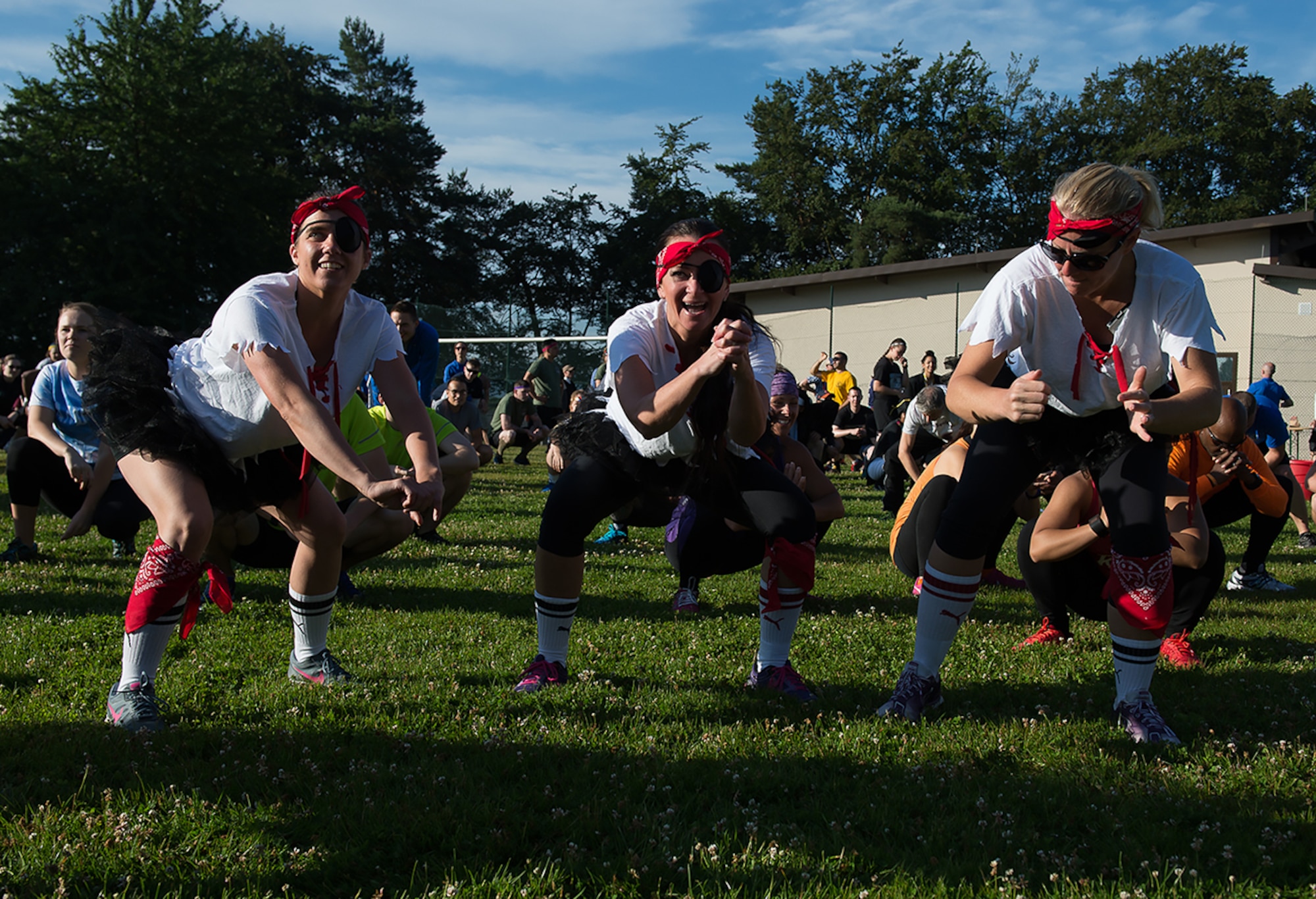 Mudless Mudder participants perform squats during a warm-up, July 8, 2016 at Ramstein Air Base, Germany. More than 98 teams signed-up to compete in the five-kilometer obstacle course for Resilience Day. (U.S. Air Force photo/ Senior Airman Nesha Humes)