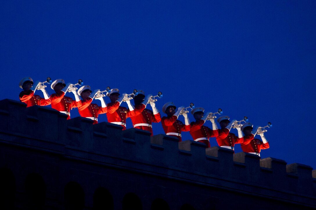 The United States Marine Drum and Bugle Corps performs during the Evening Parade at Marine Barracks Washington, D.C., July 8, 2016. The guests of honor for the parade were Mr. Christian Brose, majority staff director, U.S. Senate Armed Services Committee, the Honorable Elizabeth L. King, minority staff director, U.S. Senate Armed Services Committee, Mr. Robert L. Simmons, majority staff director, U.S. House Armed Services Committee and Mr. Paul Arcangeli, minority staff director, U.S. House Armed Services Committee. The hosting official was Lt. Gen. Kenneth McKenzie Jr., director, J-5, Strategic Plans and Policy, Joint Staff. (Official Marine Corps photo by Cpl. Chi Nguyen/Released)