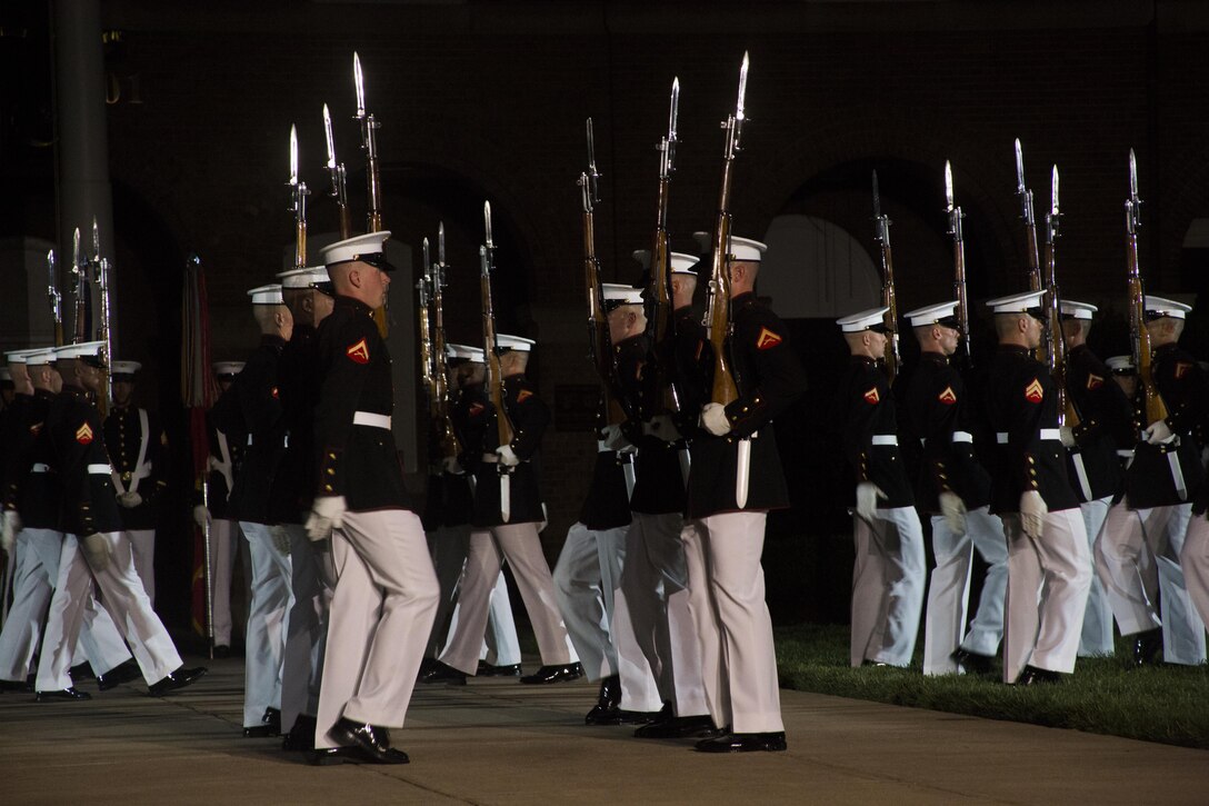 The United States Marine Corps Silent Drill Platoon performs during the Evening Parade at Marine Barracks Washington, D.C., July 8, 2016. The guests of honor for the parade were Mr. Christian Brose, majority staff director, U.S. Senate Armed Services Committee, the Honorable Elizabeth L. King, minority staff director, U.S. Senate Armed Services Committee, Mr. Robert L. Simmons, majority staff director, U.S. House Armed Services Committee and Mr. Paul Arcangeli, minority staff director, U.S. House Armed Services Committee. The hosting official was Lt. Gen. Kenneth McKenzie Jr., director, J-5, Strategic Plans and Policy, Joint Staff. (Official Marine Corps photo by Lance Cpl. Robert Knapp/Released)