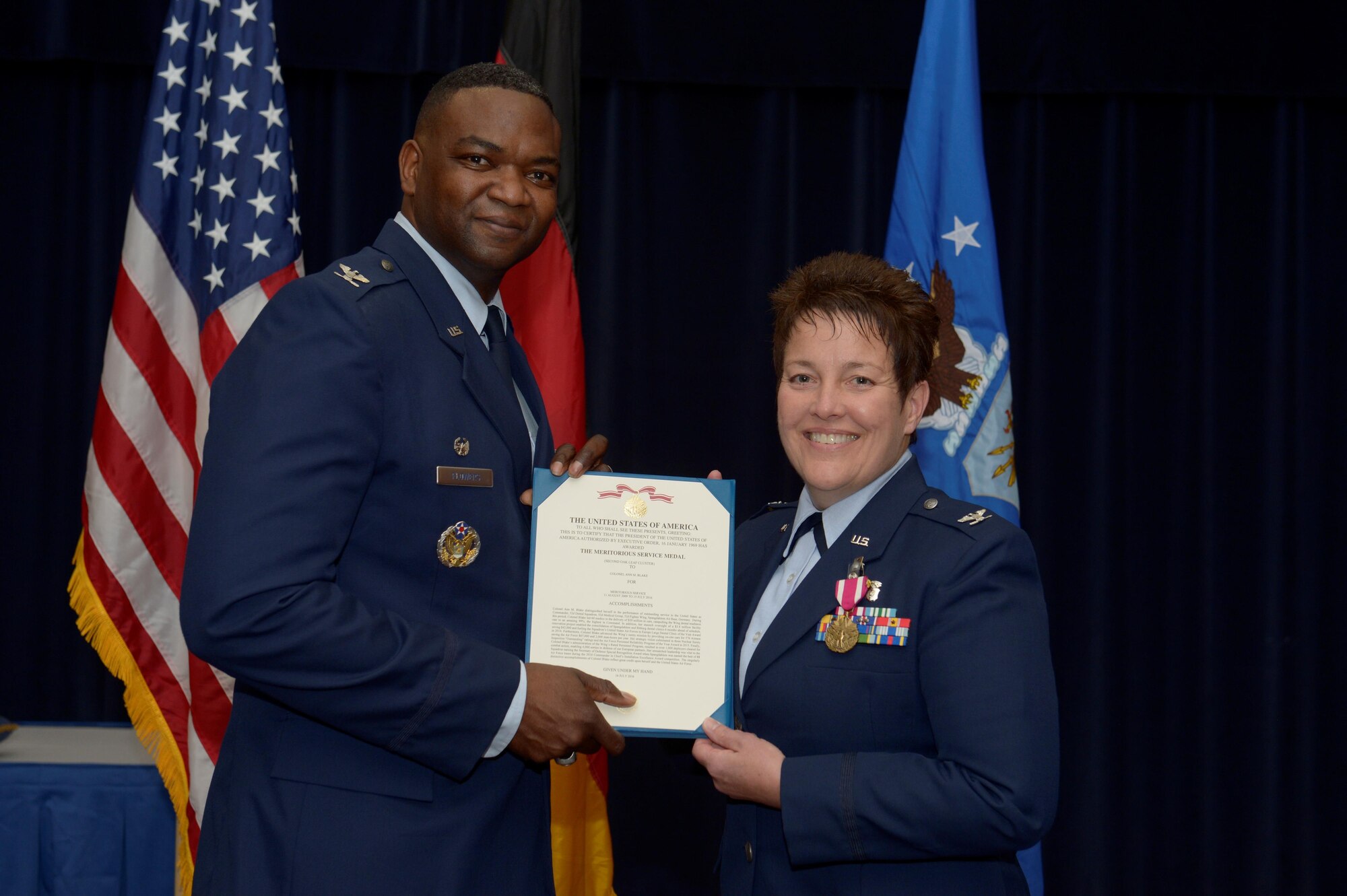 U.S. Air Force Col. Alfred Flowers, 52nd Medical Group commander, left, presents the Meritorious Service Medal to U.S. Air Force Col. Ann Blake, outgoing 52nd Dental Squadron commander, during the 52nd DS change of command ceremony on Spangdahlem Air Base, Germany, July 11, 2016. Blake received the MSM in recognition of her service of leading the 52nd DS. (U.S. Air Force photo by Staff
Sgt. Jonathan Snyder/Released)