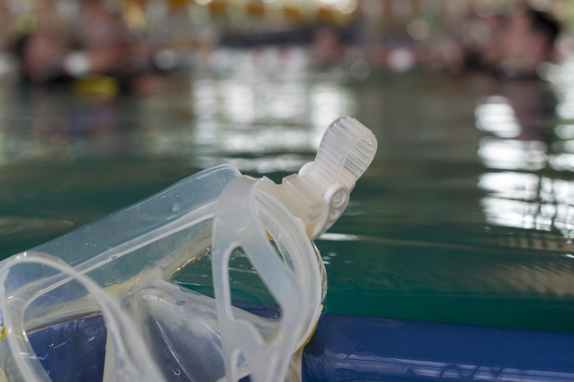 Goggles lay on the edge of a pool during the Ramstein Aquatic Center’s Professional Association of Diving Instructors Open Water Certification class July 7, 2016, at Ramstein Air Base, Germany. Students must undergo four days of classroom and hands-on training in the pool and two days in open water at a lake to receive their certificate. (U.S. Air Force photo/Airman 1st Class Tryphena Mayhugh)