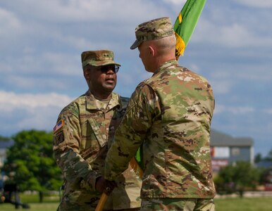 Maj. Gen. Phillip M. Churn, the commanding general for the 200th Military Police Command, passes the unit’s colors to Lieutenant General Charles. D Luckey, chief of the Army Reserve and commanding general of the United States Army Reserve Command, during Churn’s relinquishment of command ceremony at the McGlachlin Parade Field, on Fort Meade, Md., July 10, 2016.  Approximately 200 Soldiers from the command’s subordinate units attended the ceremony. The passing of the colors is a time-honored military tradition, which is symbolic of passing on the unit’s history and achievements, as well as the unit’s future. (U.S. Army Photo by Sgt. Audrey Hayes)