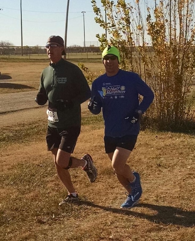 Maj. Patrick Cain, 22nd Maintenance Squadron commander, left, runs with Lt. Col Duane Richardson, 22nd Aircraft Maintenance Squadron commander, at a 5k race, Nov. 14, 2015, at Wichita, Kan. Cain was diagnosed with stage three colorectal cancer on Aug. 15, 2015. Can ran the 5k while undergoing chemotherapy and radiation treatments. 