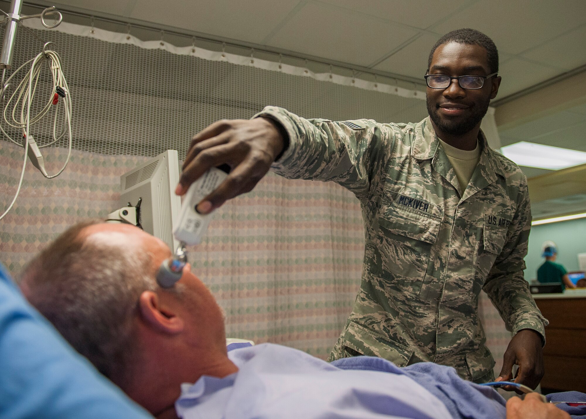 Senior Airman David McKiver, 96th Surgical Operations Squadron, takes a patient’s temperature June 30 at Eglin Air Force Base, Fla. McKiver was recently recognized as an Air Force Medical Service Trusted Care Hero due to his work ethic and quick responsive actions to provide ‘Trusted Care Anywhere.’ (U.S. Air Force photo/Ilka Cole)