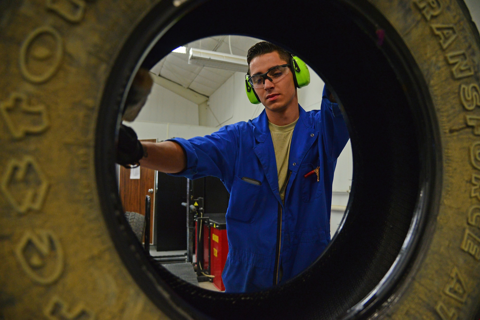 Senior Airman Brennan Popp, 341st Logistics Readiness Squadron mission generating vehicular equipment maintenance technician, lubricates the inside of a tire July 7, 2016, at Malmstrom Air Force Base, Mont. The lubrication helps the tire fit over a rim when a new tire is mounted. (U.S. Air Force photo/Airman 1st Class Daniel Brosam)