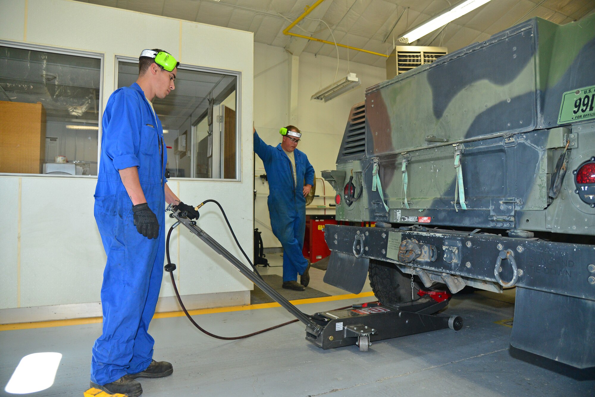 Senior Airmen Brennan Popp, left, and Hunter Dombek, 341st Logistics Readiness Squadron mission generating vehicular equipment maintenance technicians, raise a Humvee to replace its tires July 7, 2016, at Malmstrom Air Force Base, Mont. The Airmen use a lift to manually raise the vehicle and place a metal stand underneath the axle to add extra support in keeping the vehicle at the correct height and to keep them safe. (U.S. Air Force photo/Airman 1st Class Daniel Brosam)

