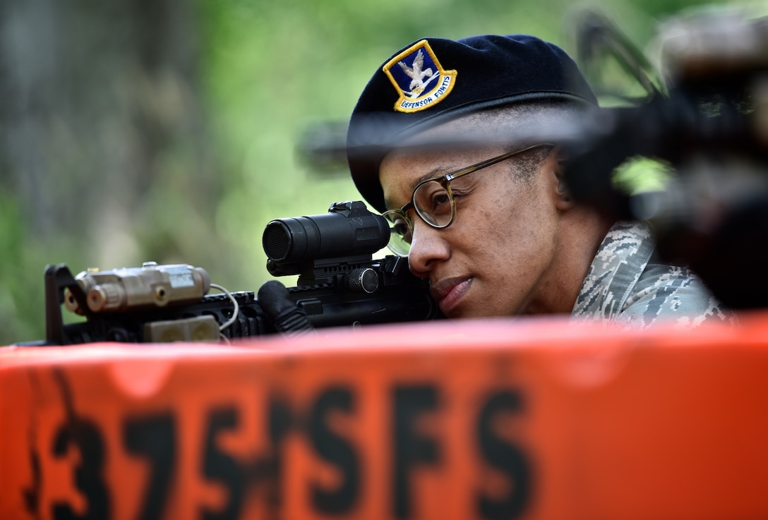 Staff Sgt. Gina Finley, a security forces team member with the 932nd Airlift Wing takes aim during a practice run before suiting up and performing shoot, move and communicate training July 9, 2016, Scott Air Force Base, Illinois.  The 932nd AW Security Forces Squadron had a full weekend with land navigation, shoot, move and  communicate, combat physical training obstacle course and basic vehicle convoy procedures.  (U.S. Air Force photo/Tech. Sgt. Christopher Parr)