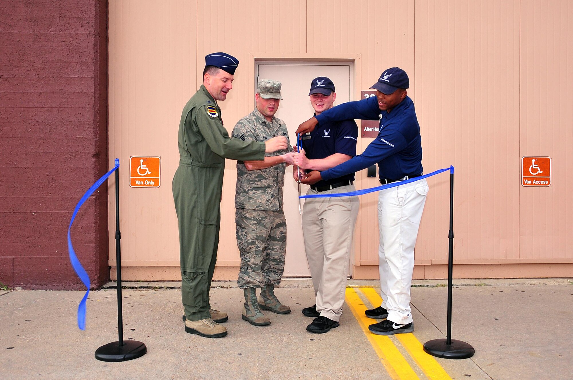 U.S. Air Force Col. Marty Reynolds, commander of the 55th Wing, joins Offutt Field House staff members in cutting the ribbon to the new after-hours facility at Offutt Air Force Base, Neb., July 7, 2016.  The 1,000 square foot corner of the Department of Defense’s largest fitness facility will provide access to fitness equipment for swing shift members of Team Offutt.  (U.S. Air Force photo by D.P. Heard/Released)