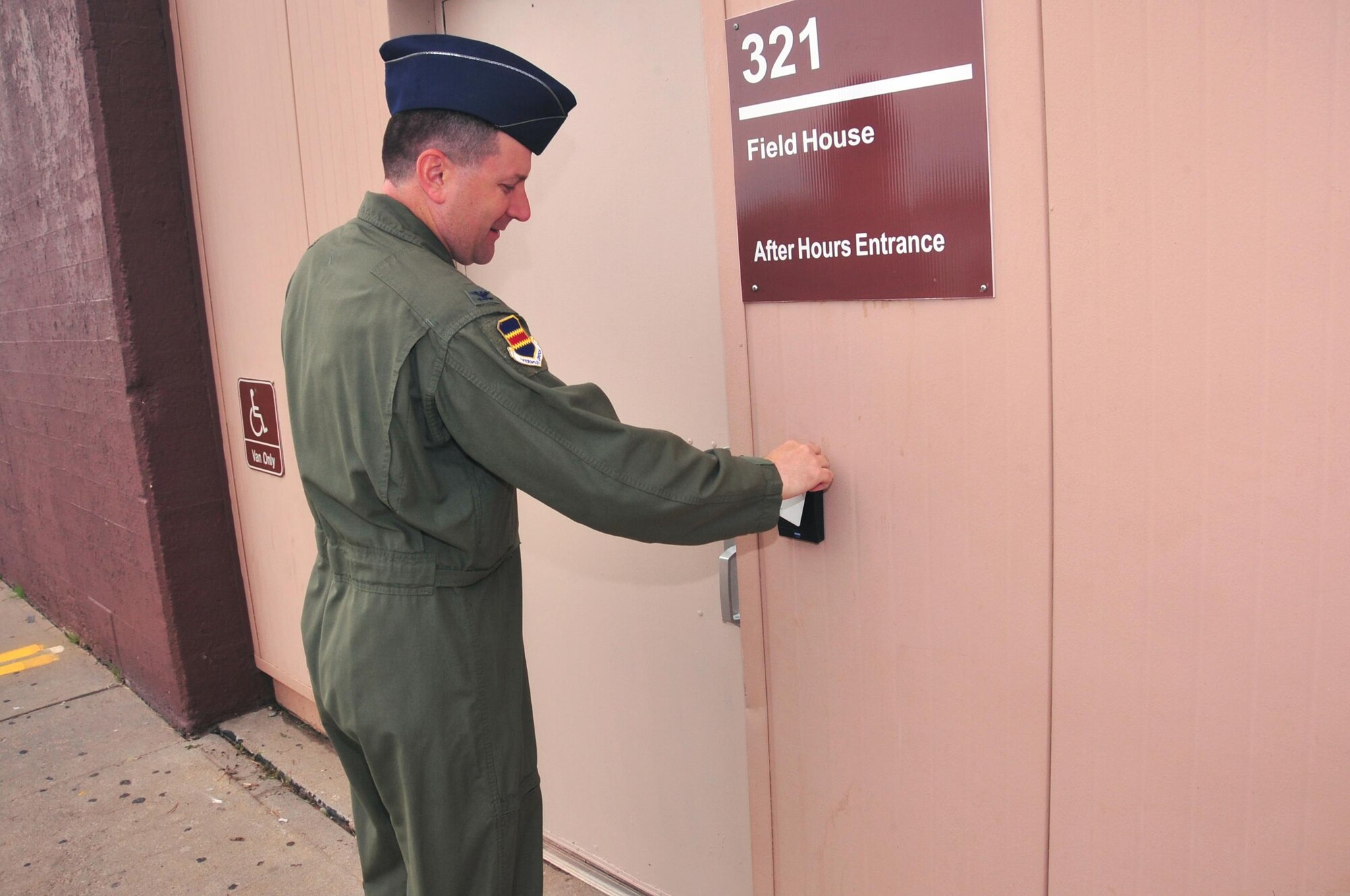 U.S. Air Force Col. Marty Reynolds, commander of the 55th Wing, uses his newly enabled common access card to enter the after-hours field house gym at Offutt Air Force Base, Neb., July 7, 2016.  Airmen will now have round-the-clock access to the fitness facility.  (U.S. Air Force photo by D.P. Heard/Released)