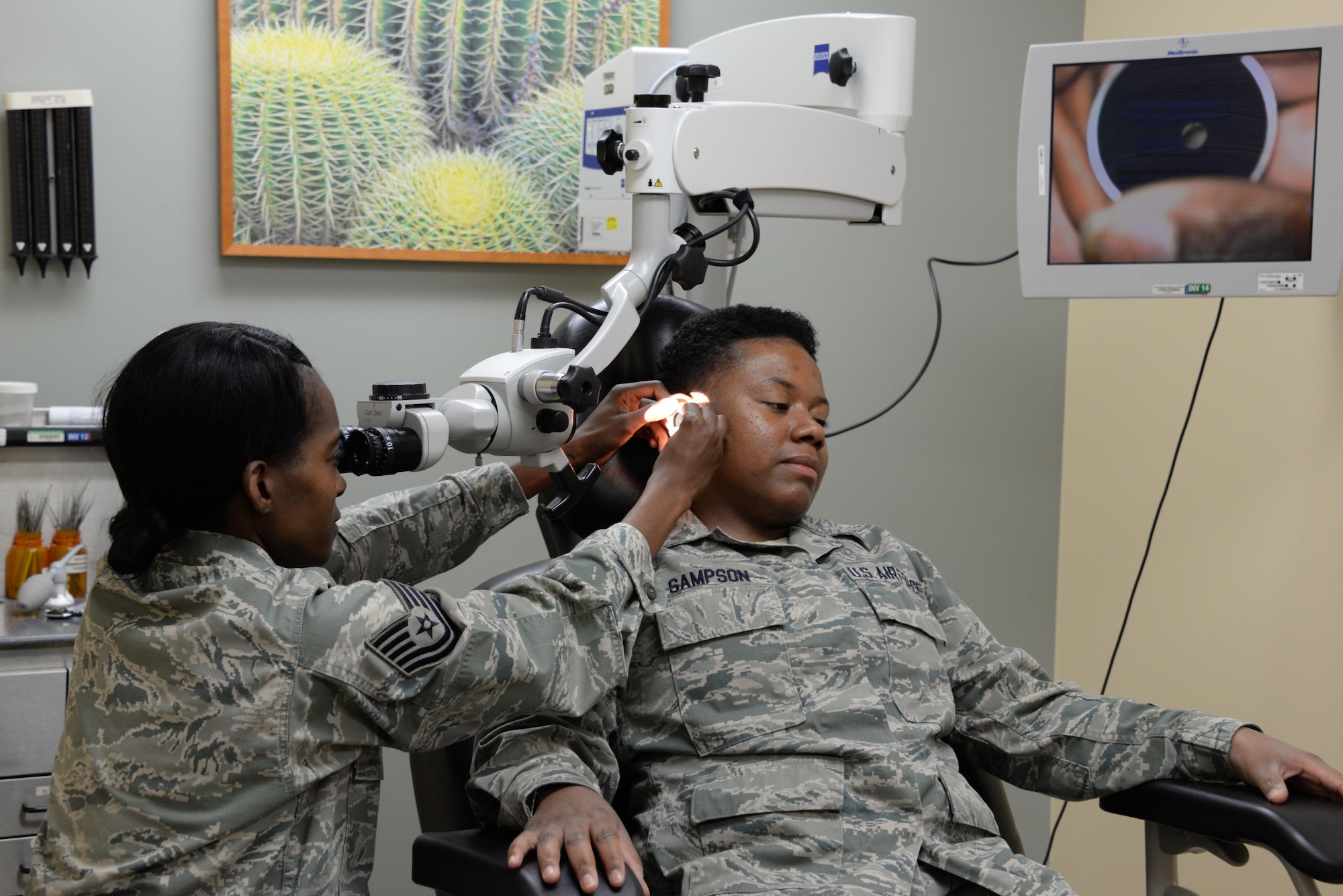 Tech. Sgt. Shineka McElvey, 60th Surgical Operations Squadron otolaryngology technician, performs an ear cleaning exam  to remove obstructions July 6 at Travis Air Force Base, California. McElvey works in the Ear, Nose and Throat Clinic at David Grant USAF Medical Center. 