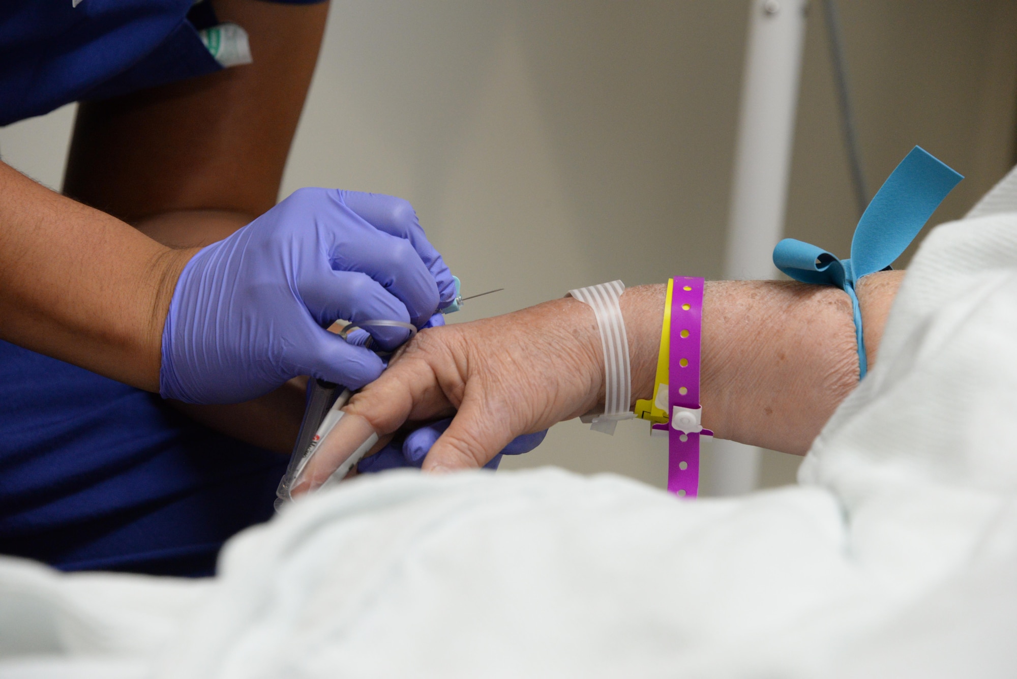 Airman 1st Class Hugo Estrada, 60th SGCS aerospace medicine technician, draws blood from a patient July 6 at David Grant USAF Medical Center. 