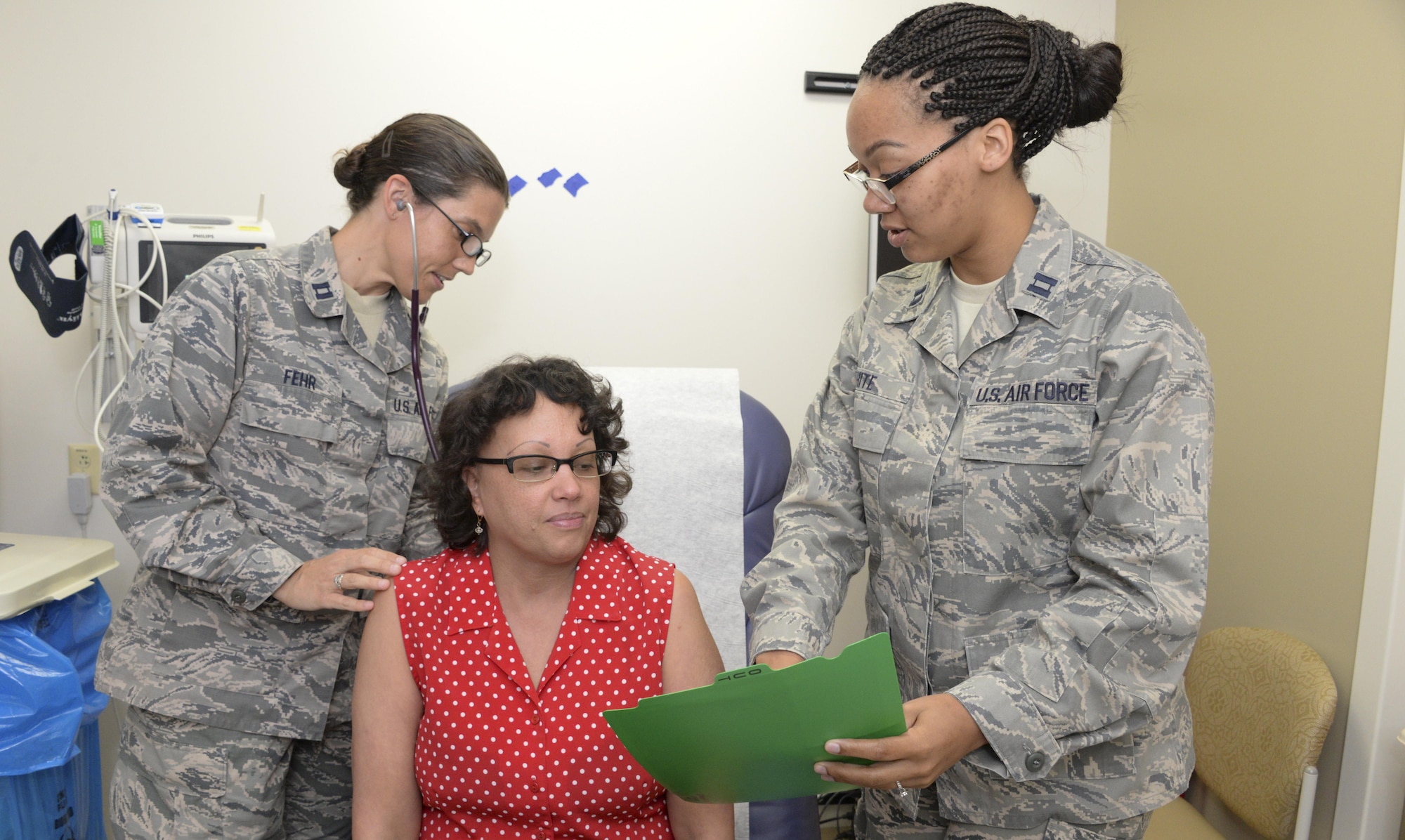Capt. Angela Hite, 60th SGCS nurse practitioner, and Capt. Jessica Fehr, 60th SGCS certified nurse midwife, check the vitals of a patient July 6 at David Grant USAF Medical Center's Women's Health Clinic. 