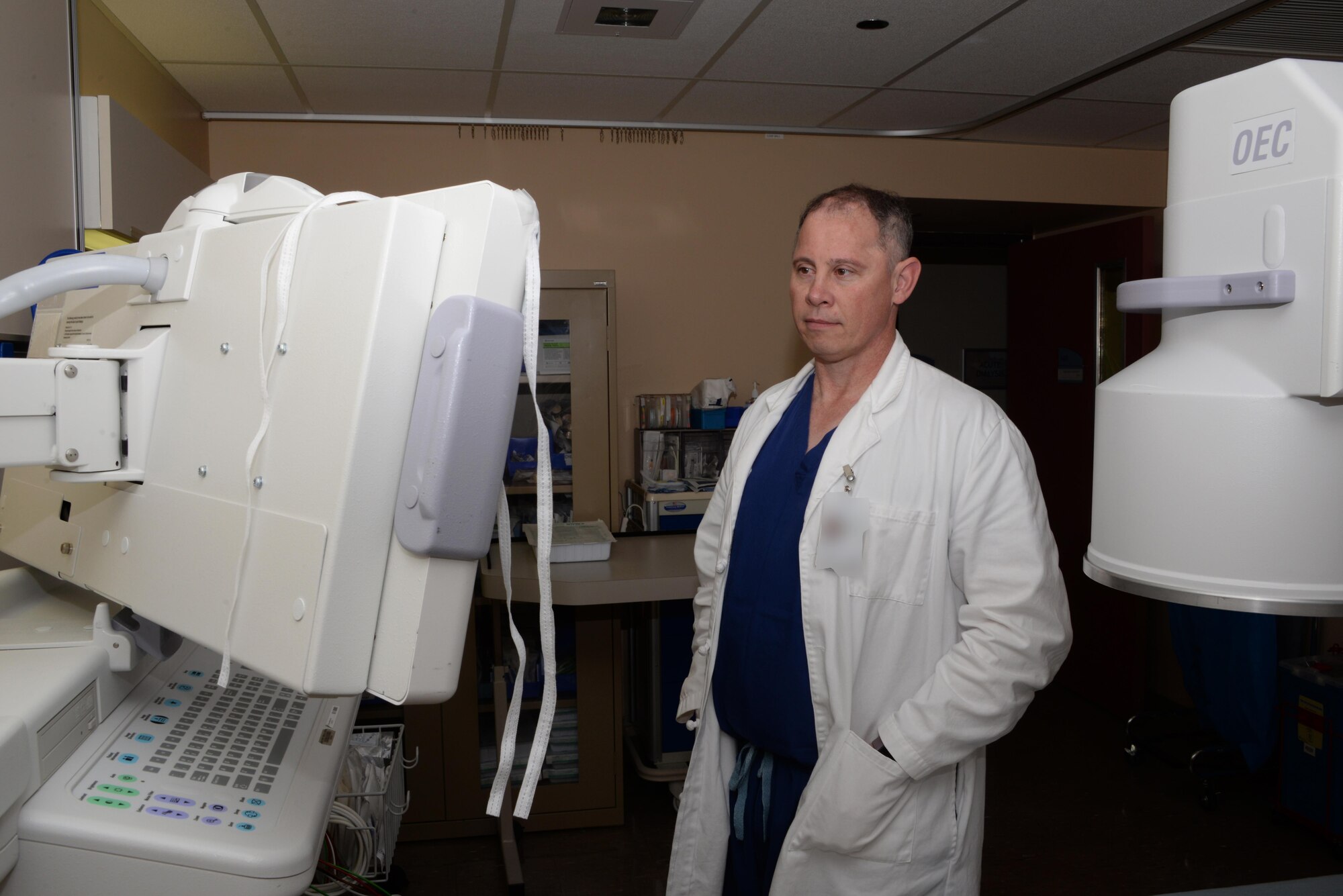 Dr. (Retired U.S. Army Lt. Col.) Ronald White, 60th Medical Surgical Operations Squadron chief of anesthesia and pain medicine, reviews X-rays in the David Grant USAF Medical Center at Travis Air Force Base, Calif., July 1, 2016. White oversees operations of the DGMC's Pain Clinic which opened in April 2016. The clinic provides services for patients experiencing acute pain, as well as chronic pain. Photo altered for security purposes. (U.S. Air Force photo by Tech. Sgt. James Hodgman/Released)
