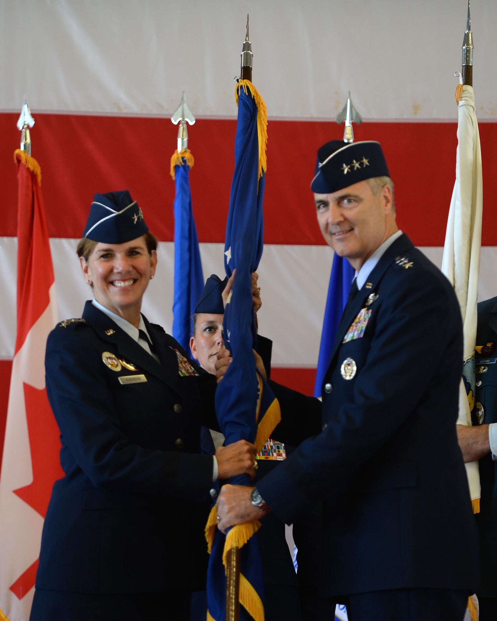 Gen. Lori Robinson, commander of North American Aerospace Defense Command and United States Northern Command, passes the guidon to Lt. Gen. Scott Williams, the incoming commander of Continental U.S. NORAD Region-1st Air Force (Air Forces Northern), at the CONR-1st AF change of command ceremony at Tyndall AFB, Fla., July 6, 2016. First Air Force has the responsibility of ensuring the air sovereignty and air defense of the continental United States. (U.S. Air Force photo by Airman 1st Class Cody R. Miller/Released)