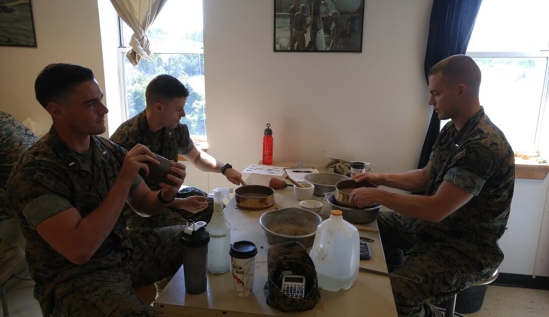 On July 7, 2016 First Lieutenant Sean Gutherie (left), Second Lieutenants Kevin Roy (middle), and Michael Hogan (right), Marines attached to Combat Engineer Officer course 7-16 (CEO 7-16); perform a sedimentation test during a soil classification practical application training. The sedimentation test is an important step in determining the suitability of the soil as construction material.
