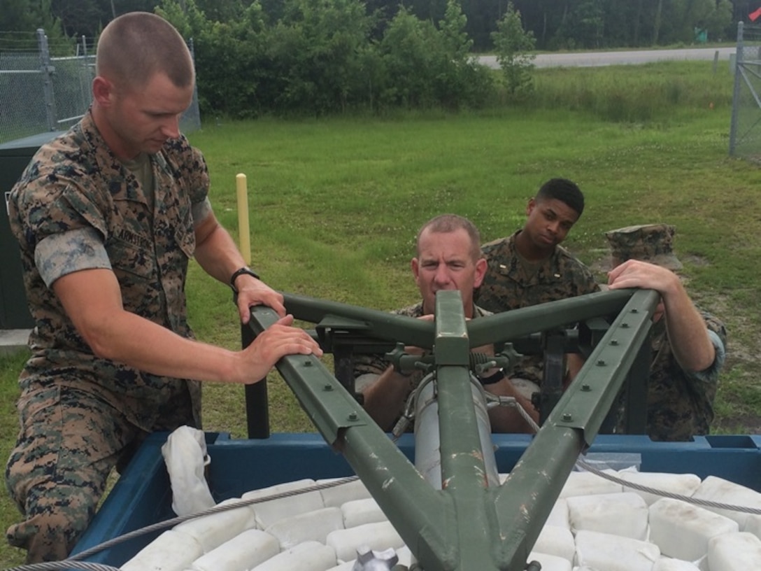 On June 16, 2016 Staff Sergeant Brett Armstrong, an instructor with Combat Engineer Instruction Company; instructs Marines attached to Combat Engineer Officer course 5-16 (CEO 5-16) on the Mine Clearing Line Charge at Marine Corps Engineer School aboard Camp Lejeune, N.C. Combat Engineer Officer students learn about various Marine Corps breaching assets; the Mine Clearing Line Charge is used to clear enemy minefields and other obstacles. Pictured from left to right: Staff Sergeant Brett Armstrong, and Second Lieutenants Justin Wilkison, Aaron Graham, and Nicholas Downey.  