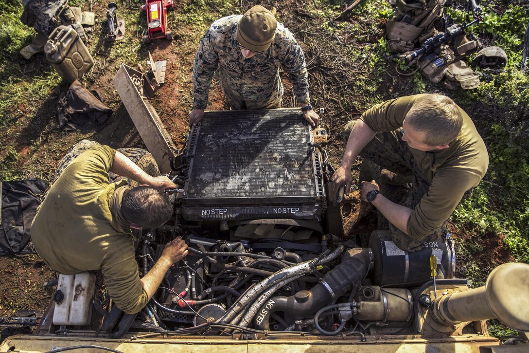 Marineswork on a Humvee engine during Exercise Hamel at the Cultana Training Area in Australia, July 8, 2016. The Marines are assigned to Headquarters and Service Company, 1st Battalion, 1st Marine Regiment, Marine Rotational Force Darwin. Marine Corps photo by Cpl. Mandaline Hatch