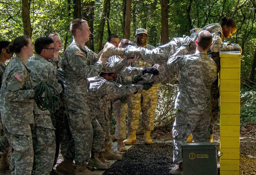 Army Reserve Staff Sgt. Vanqualis N. Battles, native of Greensboro, Florida, and Task Force Wolf instructor from Bravo Company, 4th Regiment of the 518th Training Support Battalion, 104th Training Division (LT), mentors Cadet Initial Entry Training (CIET) candidates on  the Wall Banger, the third obstacle on the Field Leaders Reaction Course (FLRC), during Cadet Summer Training (CST16), at Ft. Knox, Kentucky June 25. (U.S. Army Reserve photo by Sgt. Karen Sampson/ Released)