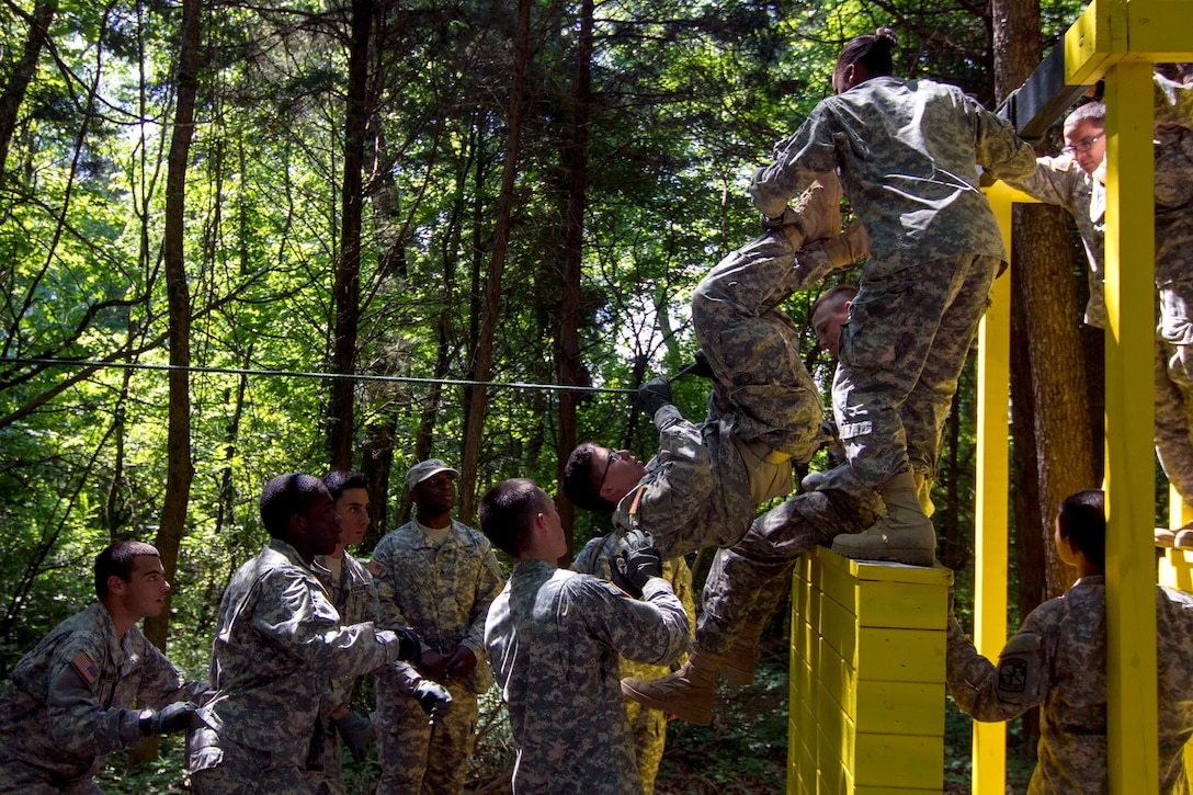 Army Reserve Staff Sgt. Vanqualis N. Battles, native of Greensboro, Florida, and Task Force Wolf instructor from Bravo Company, 4th Regiment of the 518th Training Support Battalion, 104th Training Division (LT), mentors Cadet Initial Entry Training (CIET) candidates on  the Wall Banger, the third obstacle on the Field Leaders Reaction Course (FLRC), during Cadet Summer Training (CST16), at Ft. Knox, Kentucky June 25. (U.S. Army Reserve photo by Sgt. Karen Sampson/ Released)