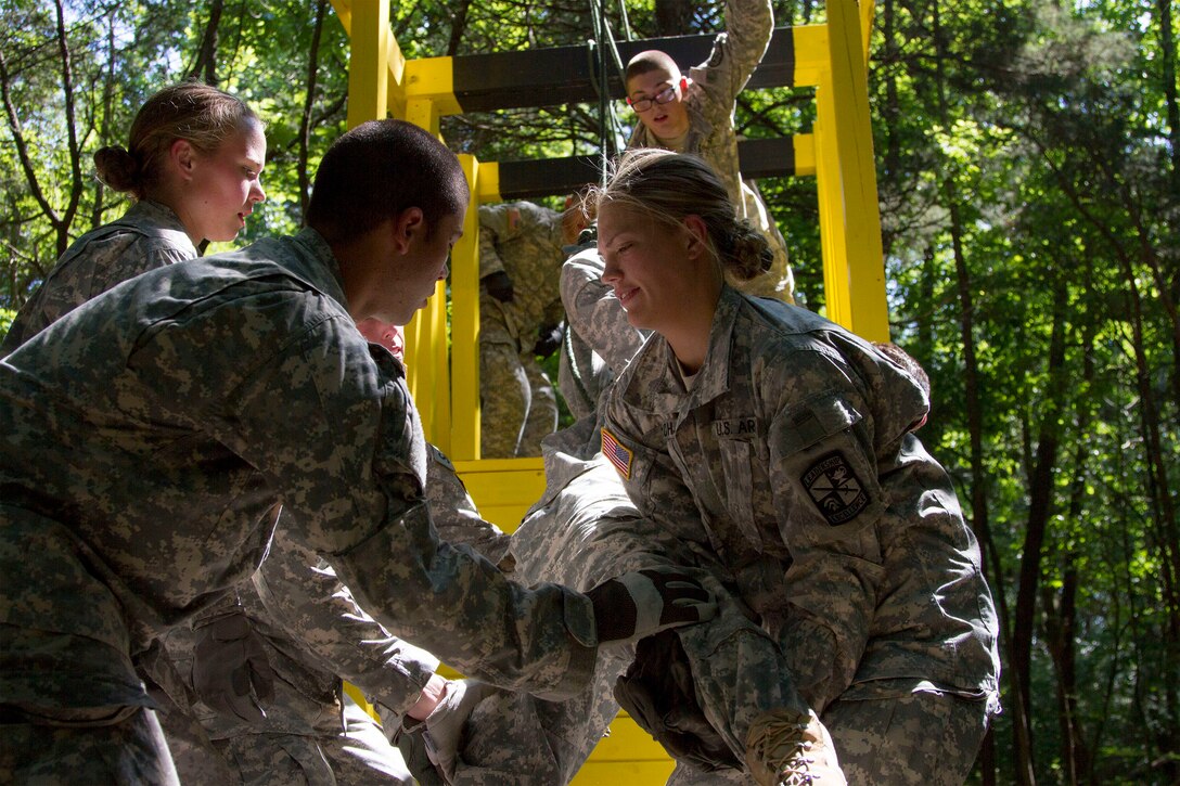 Army Reserve Staff Sgt. Vanqualis N. Battles, native of Greensboro, Florida, and Task Force Wolf instructor from Bravo Company, 4th Regiment of the 518th Training Support Battalion, 104th Training Division (LT), mentors Cadet Initial Entry Training (CIET) candidates on  the Wall Banger, the third obstacle on the Field Leaders Reaction Course (FLRC), during Cadet Summer Training (CST16), at Ft. Knox, Kentucky June 25. (U.S. Army Reserve photo by Sgt. Karen Sampson/ Released)