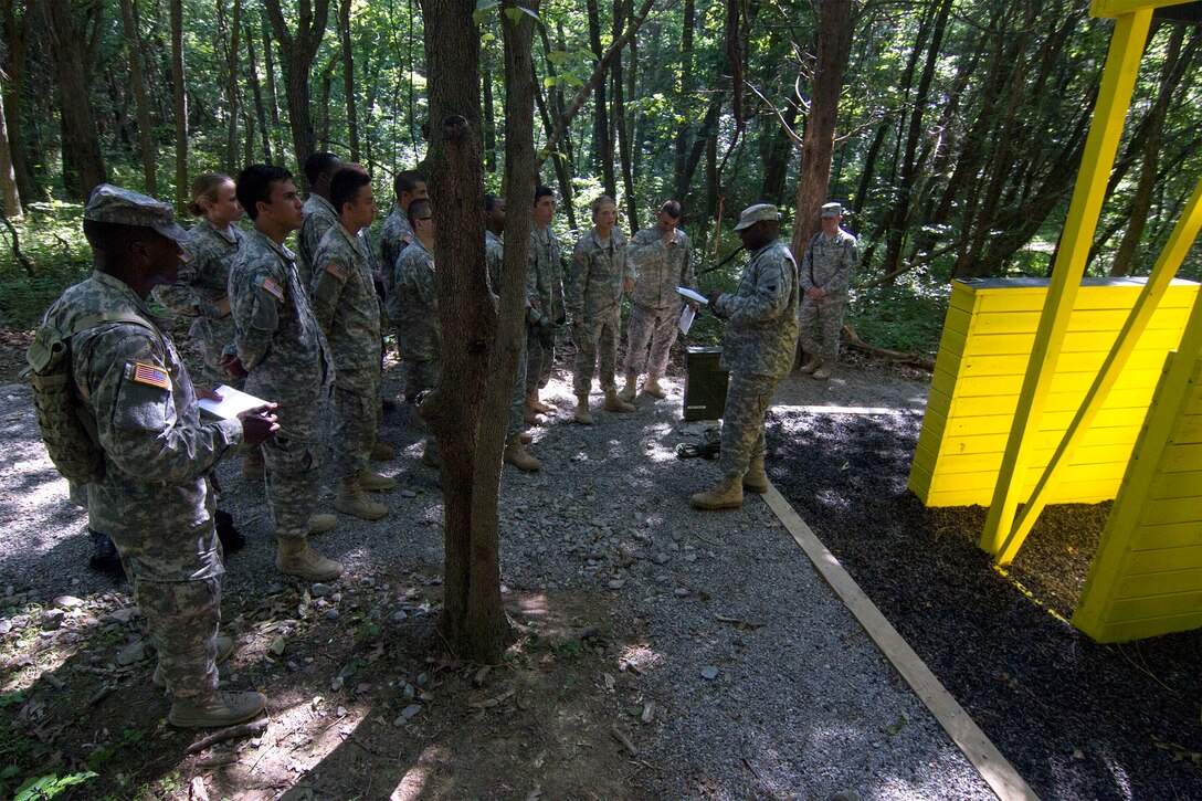 Army Reserve Staff Sgt. Vanqualis N. Battles, native of Greensboro, Florida, and Task Force Wolf instructor from Bravo Company, 4th Regiment of the 518th Training Support Battalion, 104th Training Division (LT), mentors Cadet Initial Entry Training (CIET) candidates on  the Wall Banger, the third obstacle on the Field Leaders Reaction Course (FLRC), during Cadet Summer Training (CST16), at Ft. Knox, Kentucky June 25. (U.S. Army Reserve photo by Sgt. Karen Sampson/ Released)
