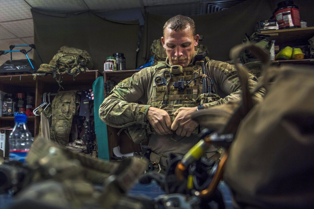 Air Force Staff Sgt. Roderick Campbell puts on his gear before participating in a personnel recovery exercise at Bagram Airfield, Afghanistan, July 9, 2016. Campbell is a pararescueman assigned to the 83rd Expeditionary Rescue Squadron. Air Force photo by Senior Airman Justyn M. Freeman