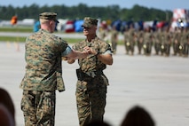 Sgt. Maj. Charles Metzger recieves the sword of office from Col. Russell Burton, Commanding Officer of Marine Corps Air Station New River, in a relief and appointment ceremony on MCAS New River July 8. Sgt. Maj. William Oldenburg retired after 30 years of service during a retirement ceremony after serving the Marines, sailors and civilians of MCAS New River as the senior enlisted advisor since April, 2014.