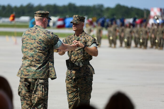 Sgt. Maj. Charles Metzger recieves the sword of office from Col. Russell Burton, Commanding Officer of Marine Corps Air Station New River, in a relief and appointment ceremony on MCAS New River July 8. Sgt. Maj. William Oldenburg retired after 30 years of service during a retirement ceremony after serving the Marines, sailors and civilians of MCAS New River as the senior enlisted advisor since April, 2014.