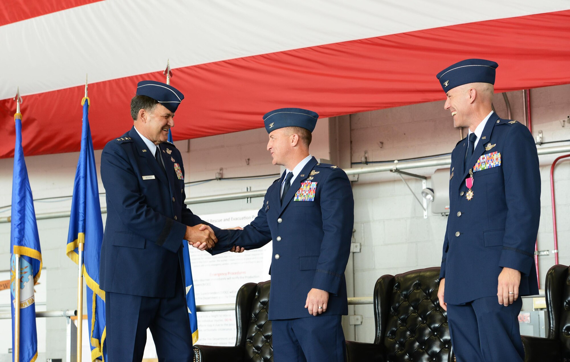 Lt. Gen. Brad Heithold, commander of Air Force Special Operations Command, congratulates Col. Nathan Green, Air Force Special Operations Air Warfare Center commander, after the AFSOAWC change of command ceremony at Hurlburt Field, Fla., July 11, 2016. Col. David Tabor, right, was the previous AFSOAWC commander. (U.S. Air Force photo/Staff Sgt. Melanie Holochwost)