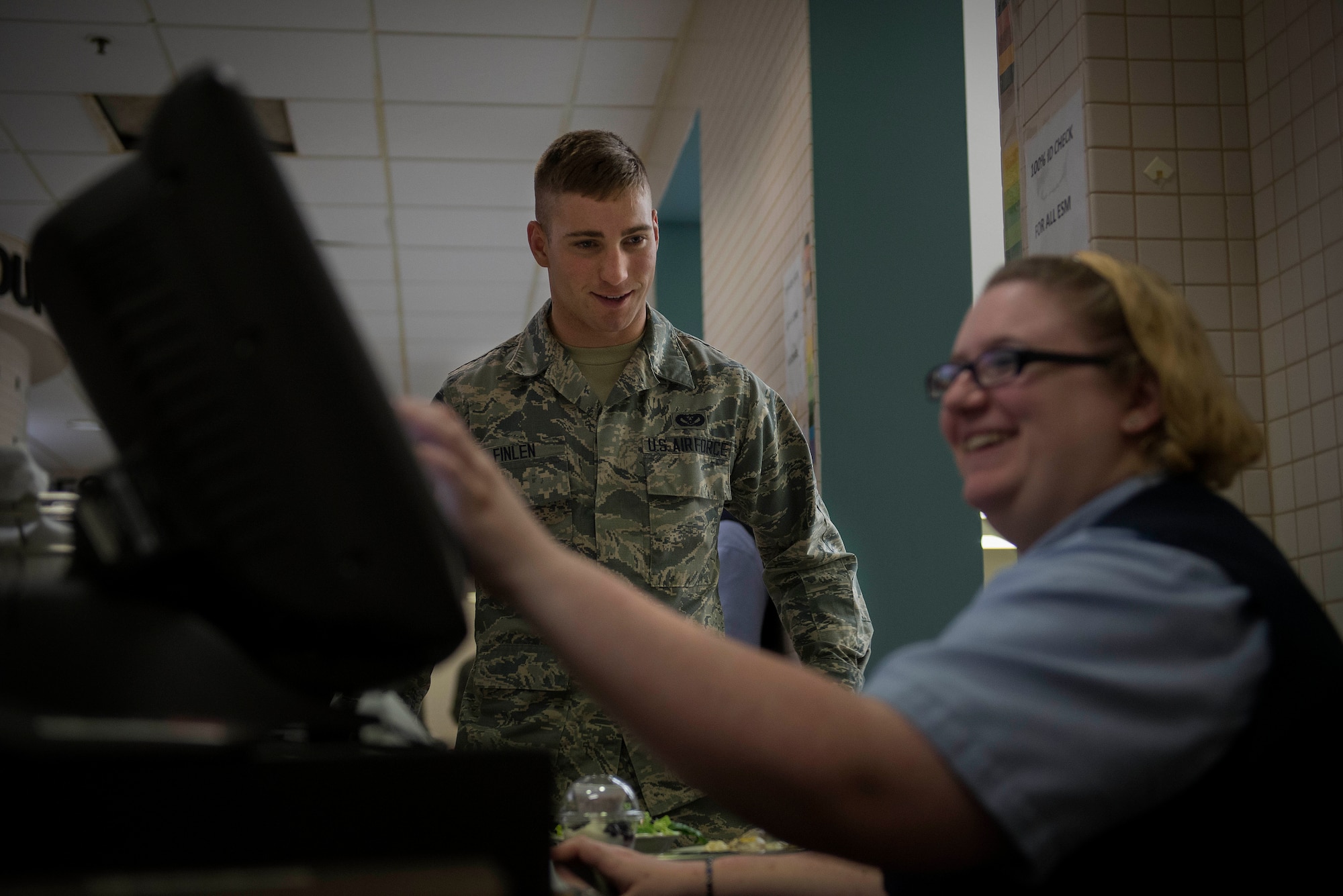 A Team Scott servicemember pays for his food at the Nightingale Inn Dining Facility at Scott Air Force Base, Illinois, June 29, 2016. On average, the dining facility serves 400-500 people a day. (U.S. Air Force photo/Senior Airman Jake Eckhardt) 