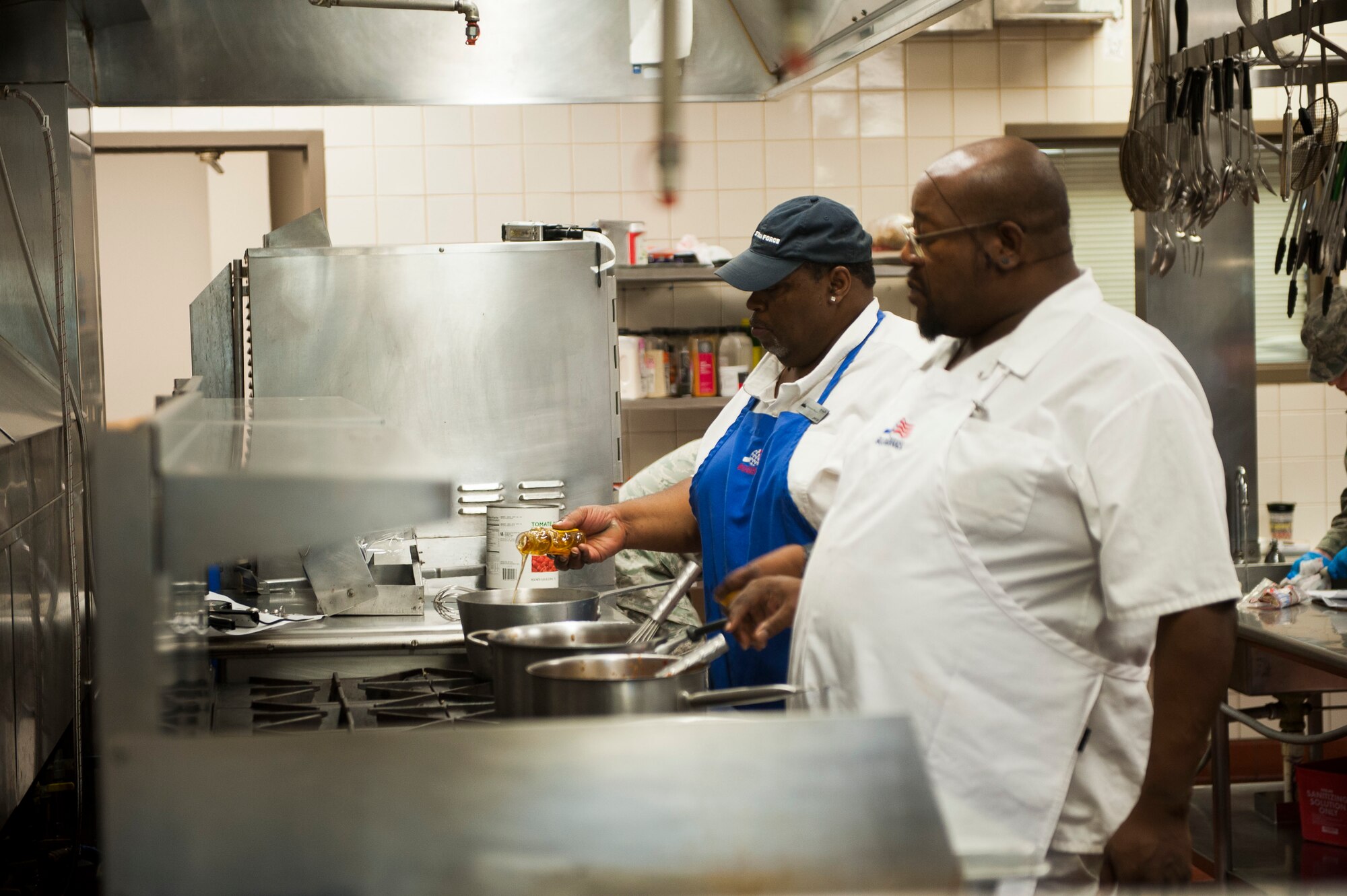 Alex Beasley and Nathan Rice, 375th Force Support Squadron chefs, prepare items for lunch at the Nightingale Inn June 29, 2016, at Scott Air Force Base, Illinois. The Nightingale Inn employs a team of active duty, reserve, national guard and civilians to prepare each meal. (U.S. Air Force photo by Staff Sgt. Clayton Lenhardt/Released)