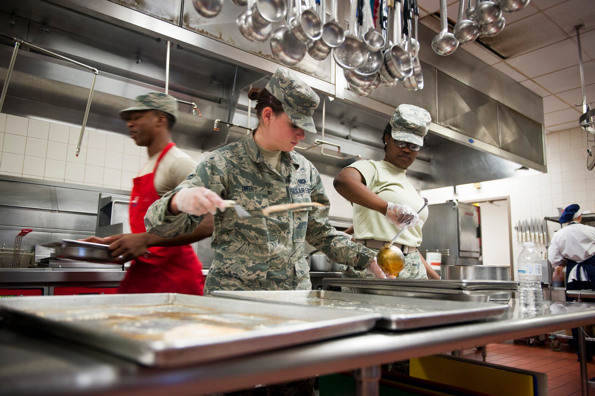Airman 1st Class Kelly Drury and A1C Zachari Doss, 126th Force Support Squadron food services apprentices, prepare a dish for lunch at the Nightingale Inn June 29, 2016, at Scott Air Force Base, Illinois. The Nightingale Inn employs a team of active duty, reserve, national guard and civilians to prepare each meal. (U.S. Air Force photo by Staff Sgt. Clayton Lenhardt/Released)