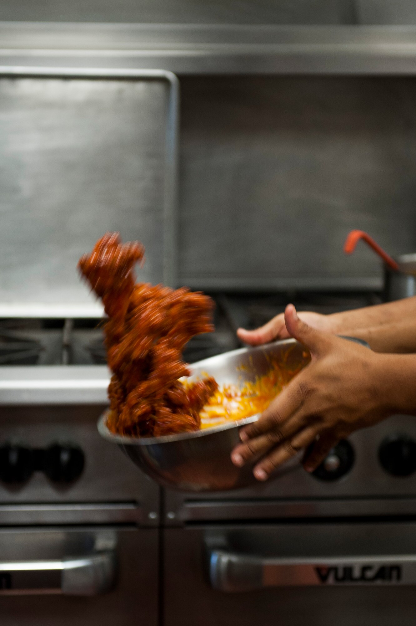 Joel Young, 375th Force Support Squadron, prepares wings for lunch at the Nightingale Inn June 29, 2016, at Scott Air Force Base, Illinois. The Nightingale Inn provides meals for all Airmen living in the dorms, as well as servicemembers temporarily assigned to the base. (U.S. Air Force photo by Staff Sgt. Clayton Lenhardt/Released)
