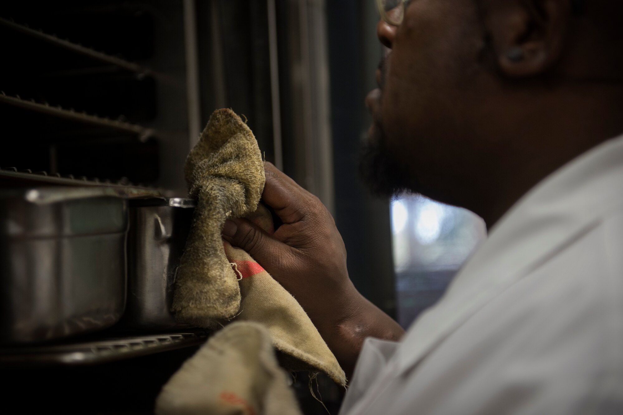 Nathan Rice, 375th Force Support Squadron chef, ensures the meat is cooking properly at the Nightingale Inn Dining Facility at Scott Air Force Base, Illinois, June 29, 2016. The dining facility serves roughly 400-500 people a day. (U.S. Air Force photo/Senior Airman Jake Eckhardt)
