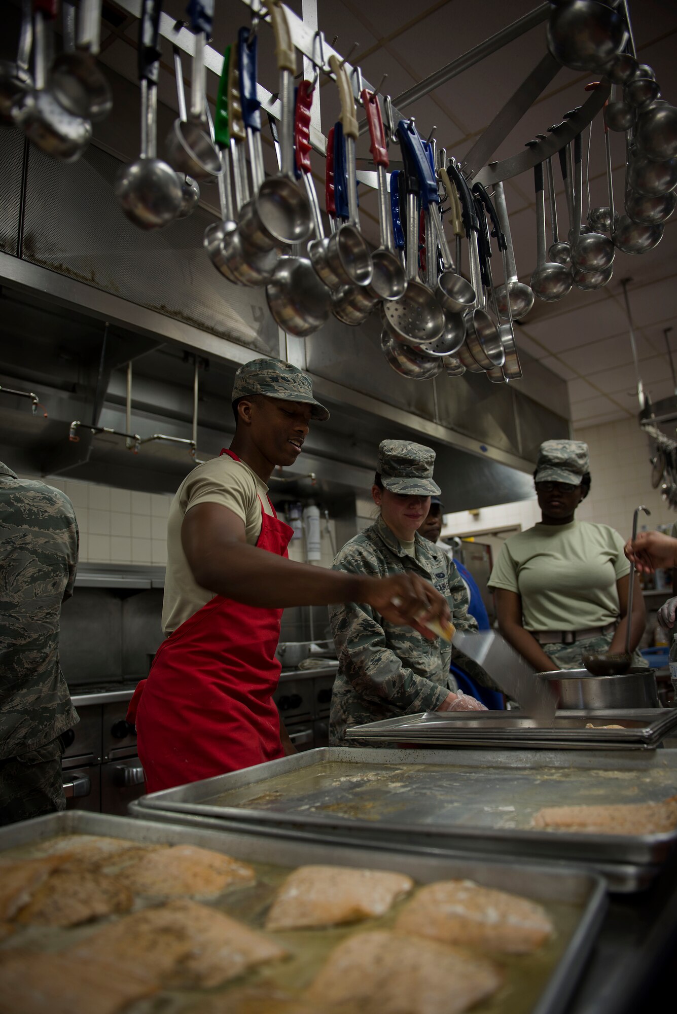 Chefs of the Nightingale Inn Dining Facility replace the chicken to be seasoned at Scott Air Force Base, Illinois, June 29, 2016. The dining facility is open year-round even through the holidays. (U.S. Air Force photo/Senior Airman Jake Eckhardt)