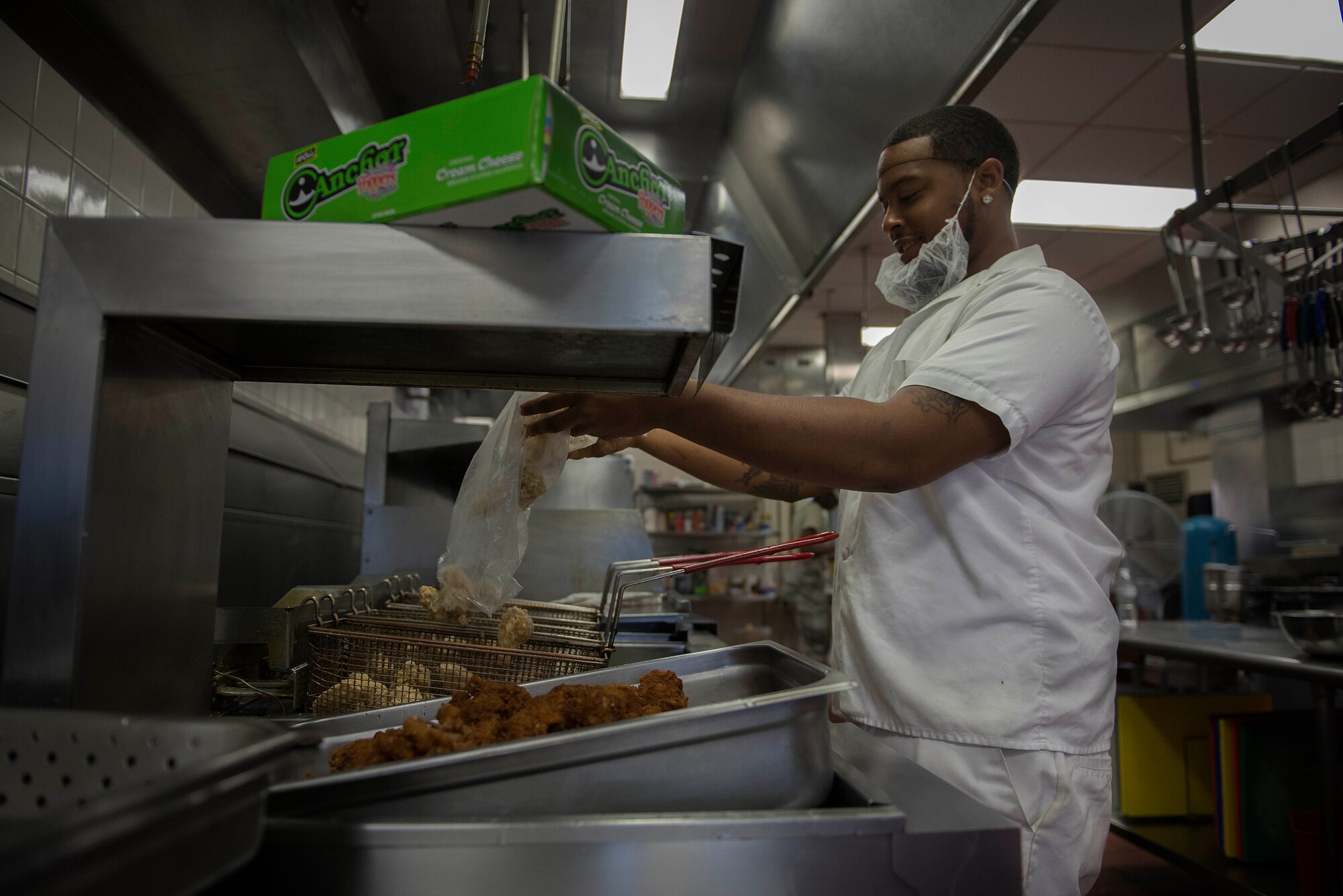 Joel Young, Nightingale Inn Dining Facility chef, prepares chicken wings for the lunch period at Scott Air Force Base, Illinois, June 29, 2016. The dining facilities' staff is made up of a mixture of active duty Air Force, Air National Guard, and civilian. (U.S. Air Force photo/Senior Airman Jake Eckhardt)